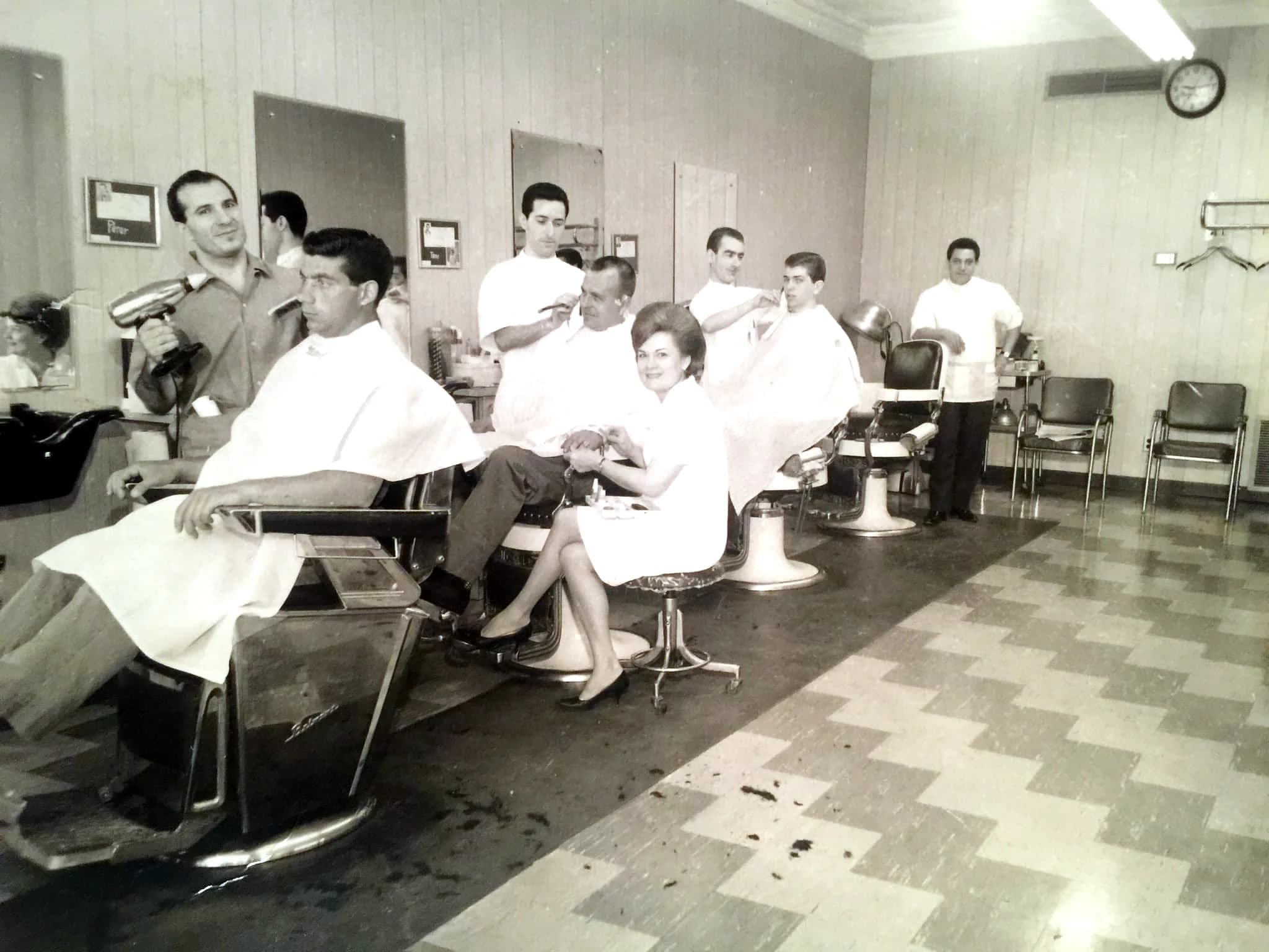 Madison's in full swing — five barbers working, a manicurist mid-set, checkerboard floor